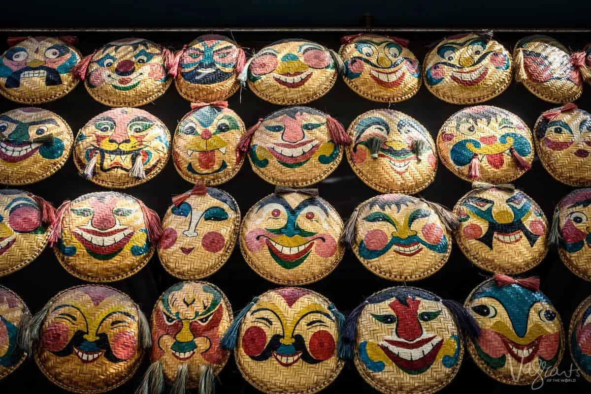 creepy faces painted on woven plates, an unusual souvenir to buy in ho chi minh city