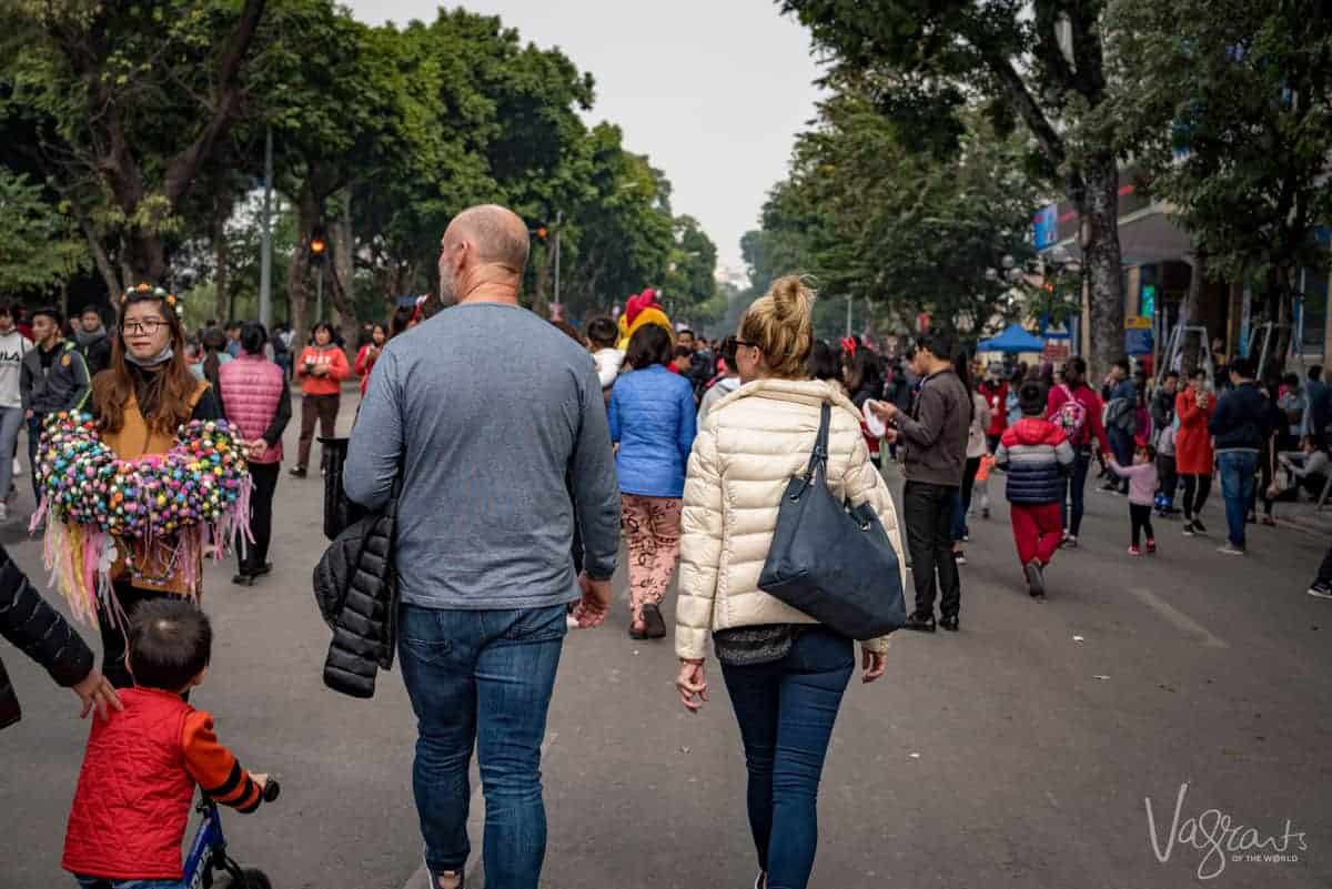 Two tourists enjoying the best thing to do in Hanoi and that is people watching.