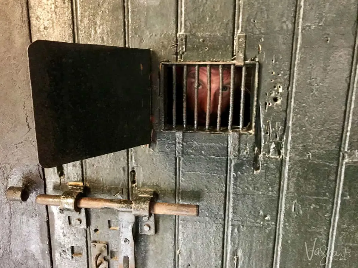 Another top thing to do in Hanoi Vietnam is to visit the Hoa Lo Prison Museum, here you see Uncle Mick behind the bars of this old prison cell door.