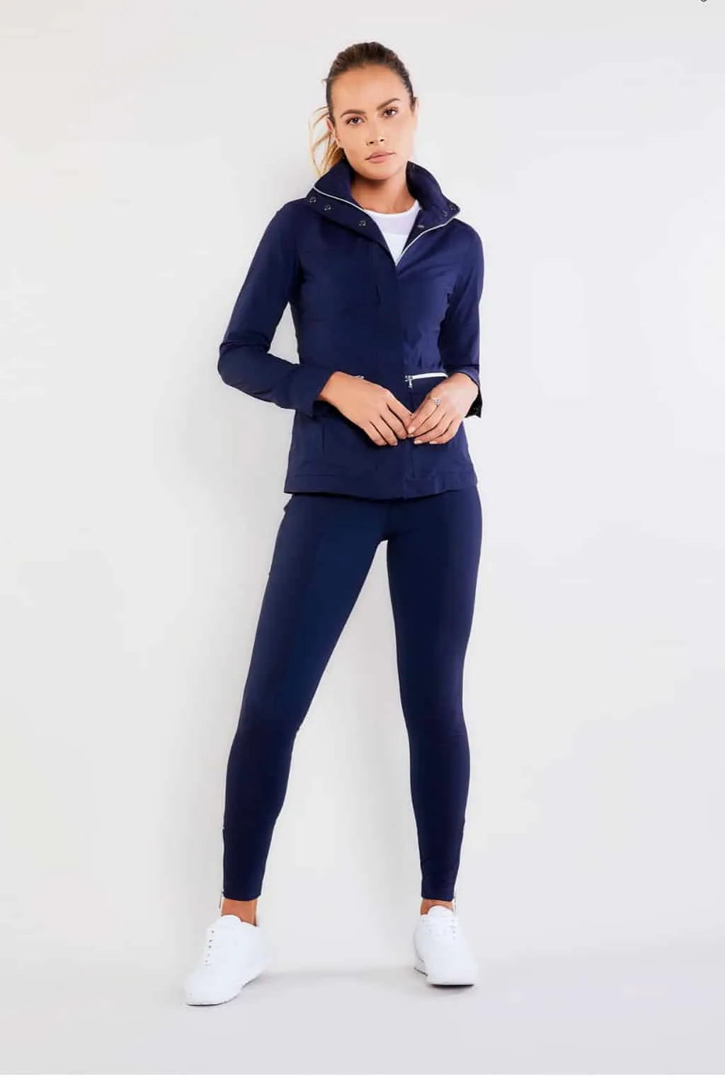 Young attractive woman modelling a navy blue travel outfit.