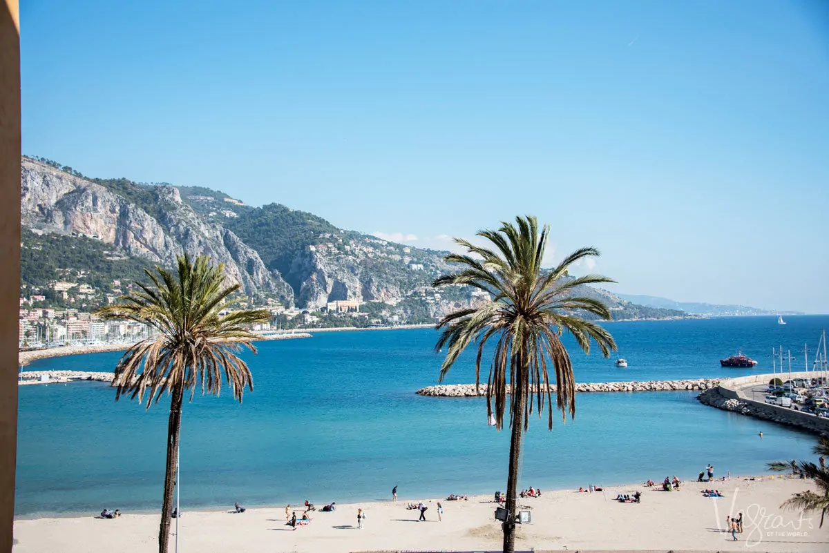 Palm trees and crystal clear blue water in the south of France.