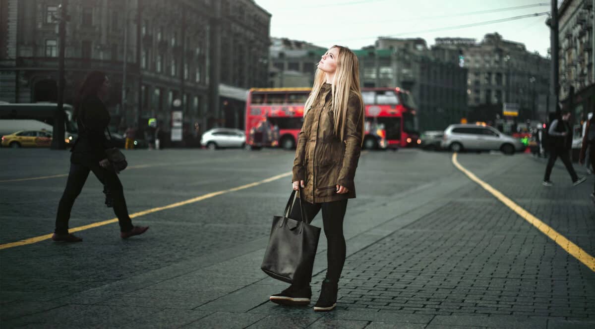 Young female traveller wearing a jacket standing in London. 