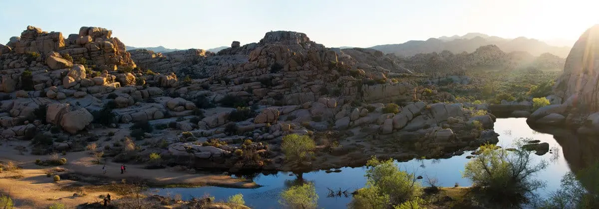 Panoramic of rock formations and the dam at Barkers Dam Hike in Joshua Tree National Park