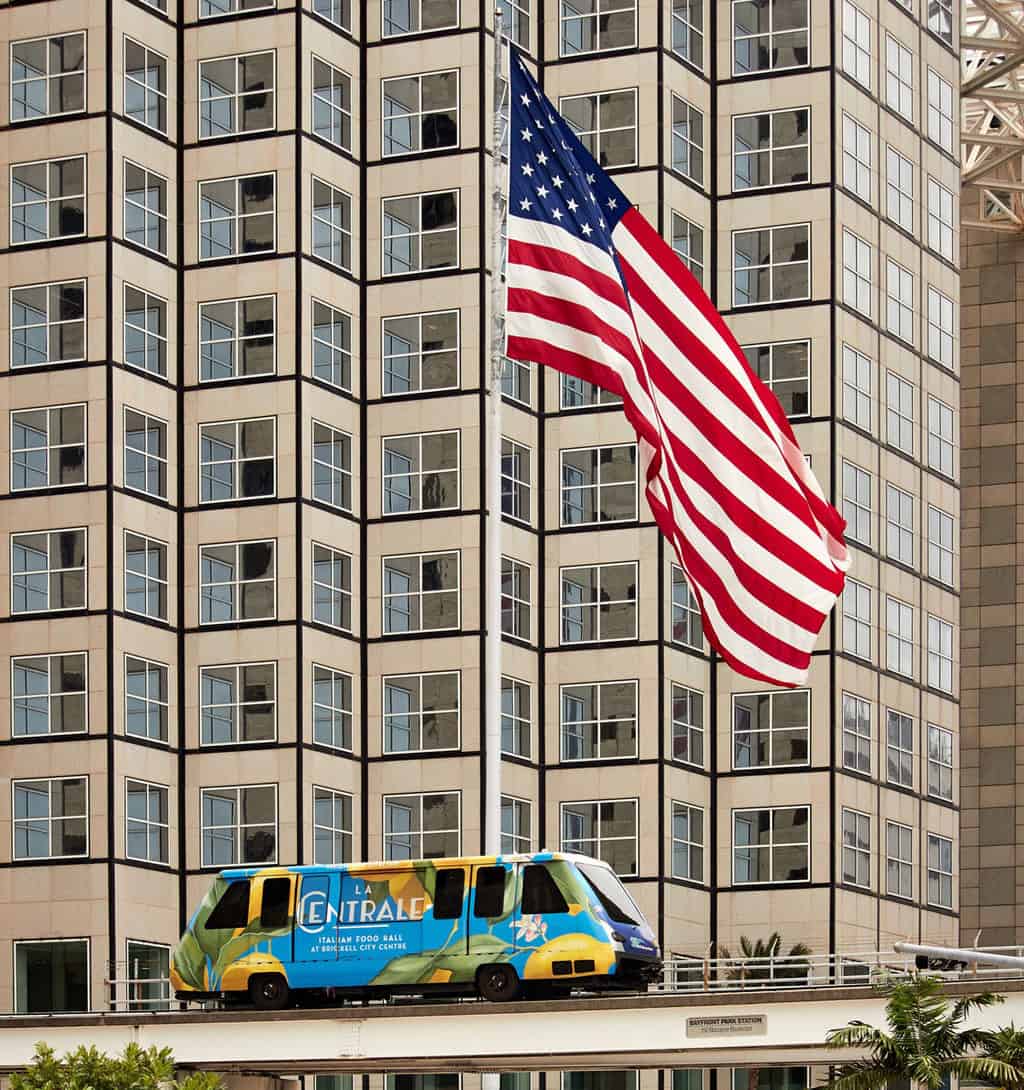 The metromover is a great way to see downtown Miami for free as it passes a giant american flag..