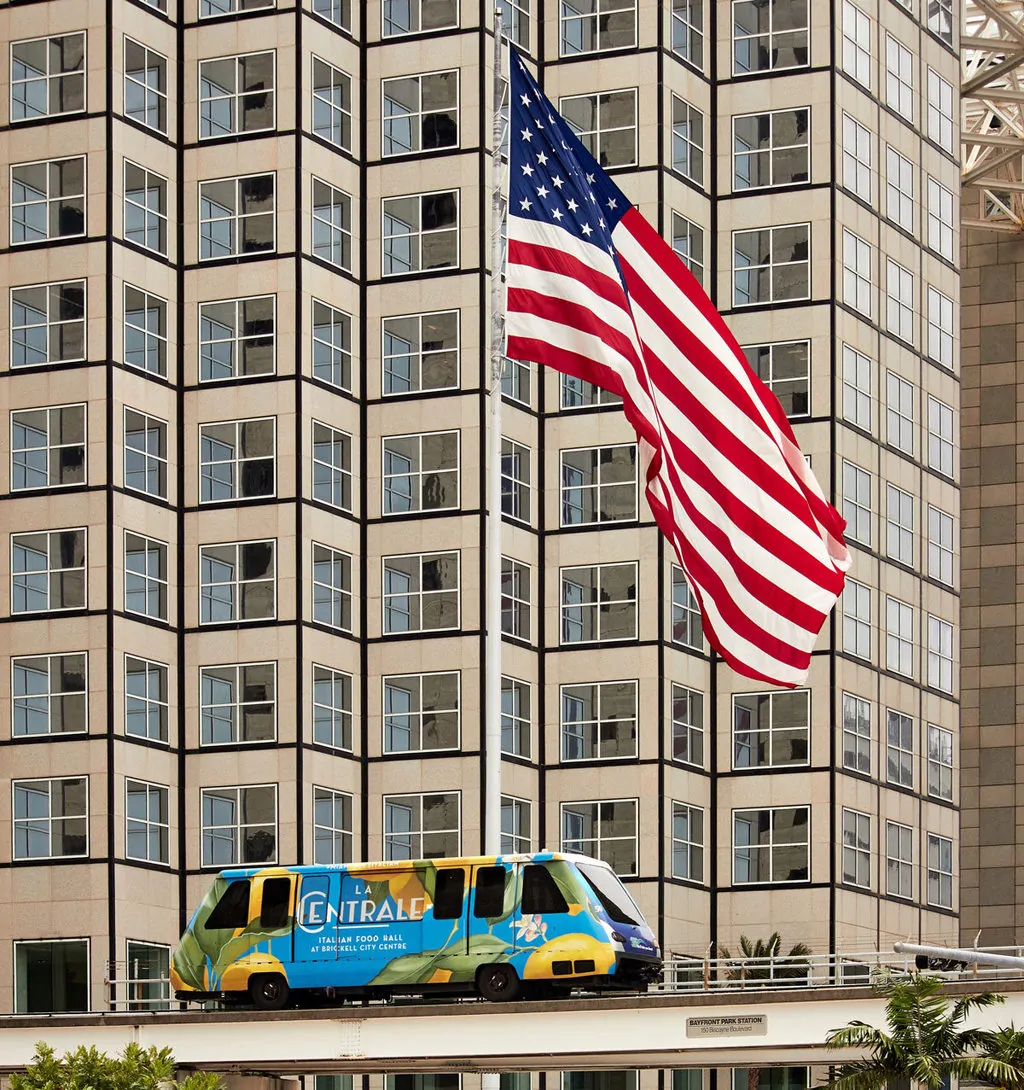 The metromover is a great way to see downtown Miami for free as it passes a giant american flag..