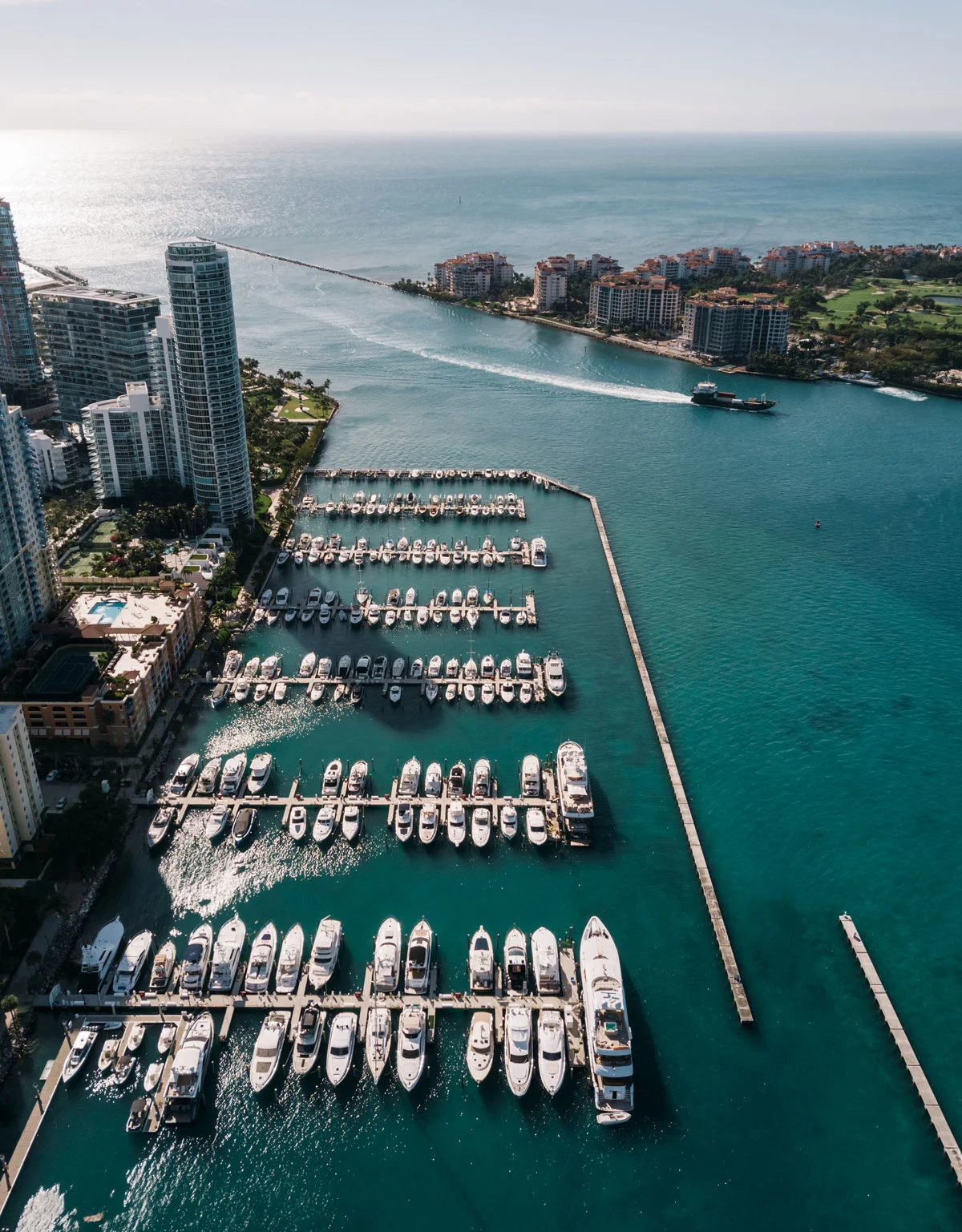 Aerial view of boats moored in from of high rise buildings.