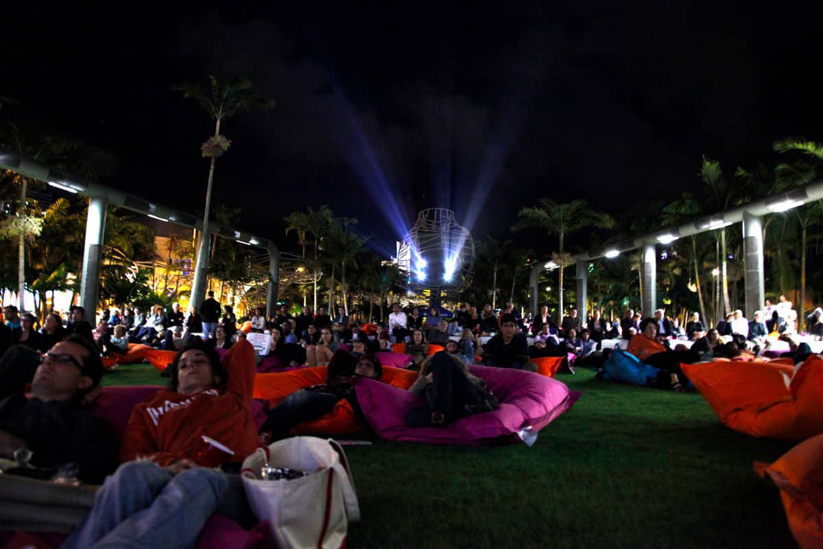 people on beanbags ate the Soundscape Series outdoor cinema in Miami. Movies and concerts are just some of the free things to do in Miami.