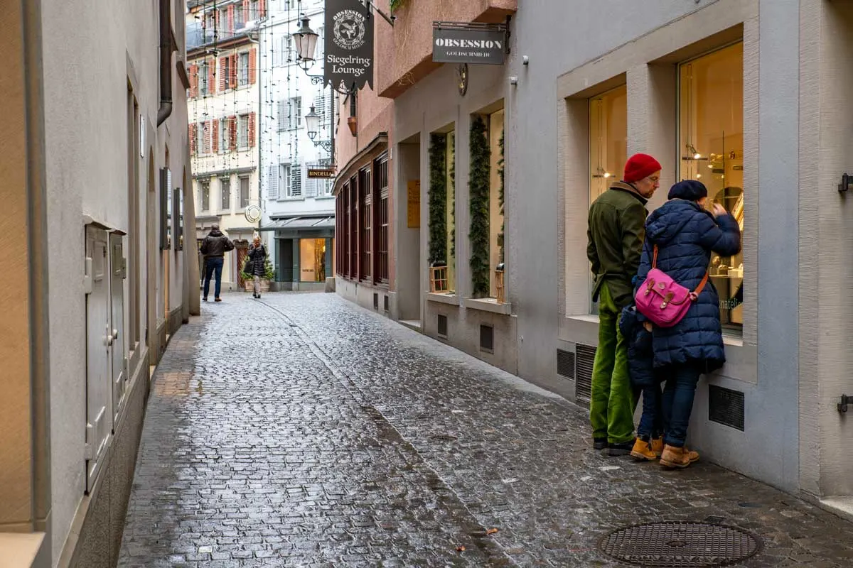 Swiss watch window shopping along the cobblestone streets of Zurich old town. 