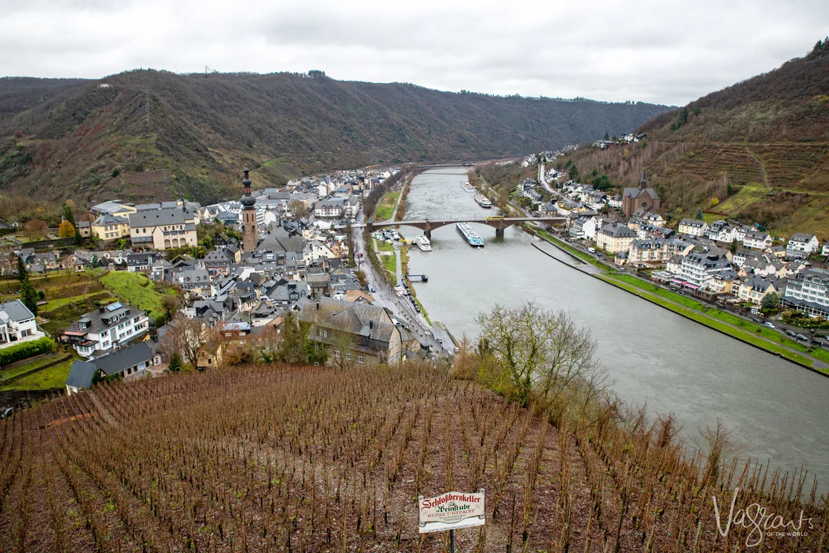 Aview down the Moselle River from above at Reichsburg Castle with winter vineyard scene on the foreground. 