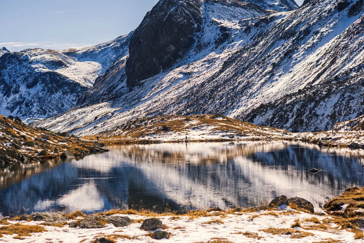 Snow covered mountain vallet with a crytal clear lake in the centre on the Fluela pass Swiss National Park