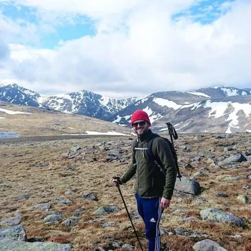 Hiker Graham Grieve on the Cairn Gorm Plateau about to begin the final ascent of Ben Macdui. Carn Tou (left) and Braeriach (right) dominating the skyline.