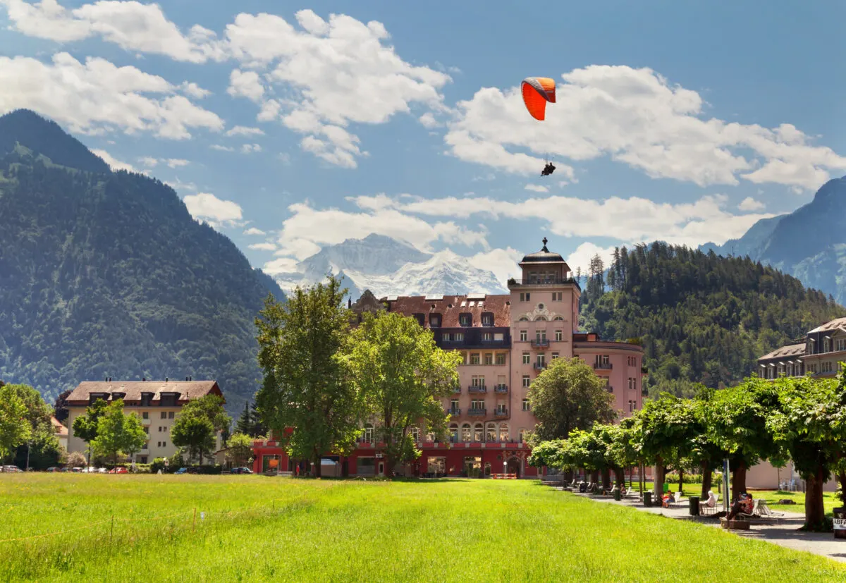 Para glider against mountains and hotel in Interlaken, Switzerland
