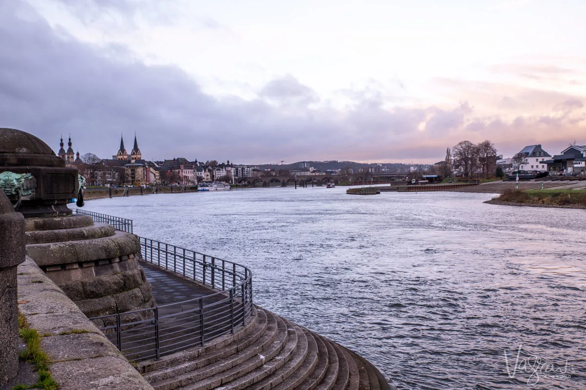 Looking down river at the town of Koblenz in Germany at the confluence of the Rhine and Moselle rivers as the sun rises. The beginning of the scenic sailing on a Rhine river cruise. 