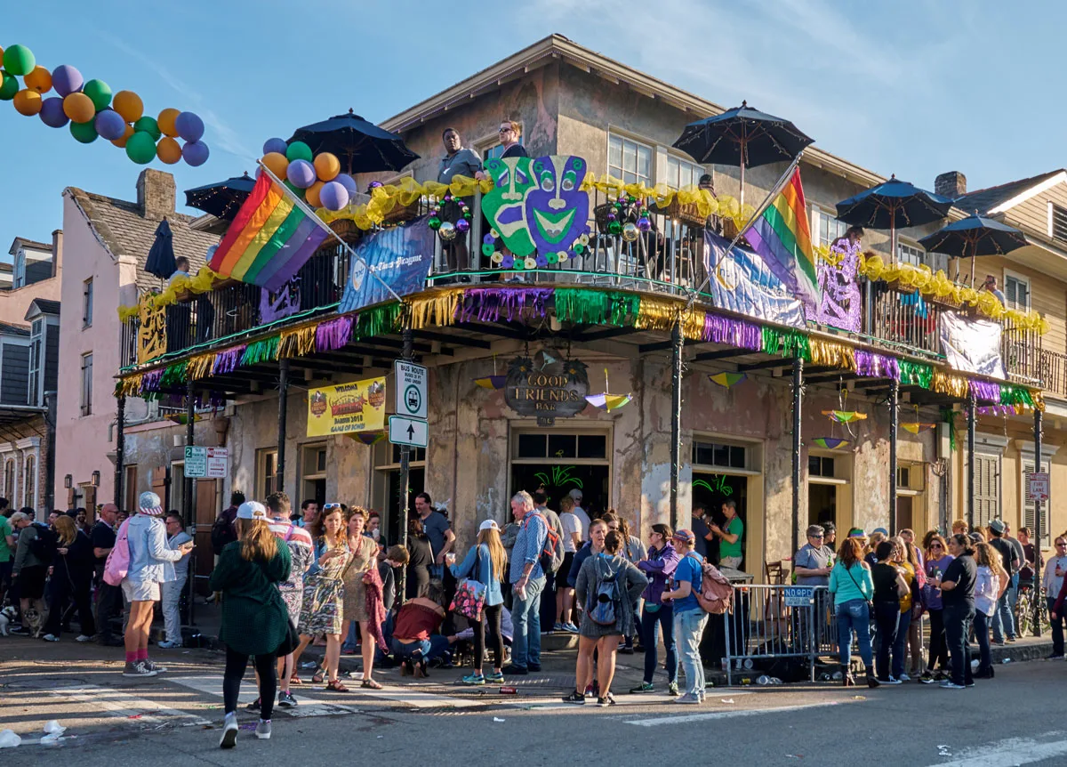 People standing outside a typical bbar in the French Qaurter of New Orleans during Mardi Gras festival