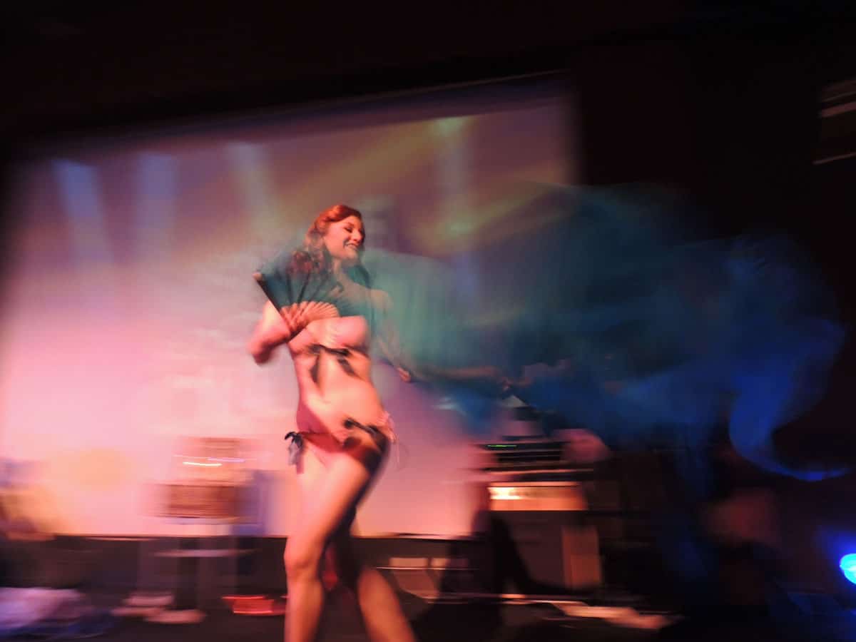 Burlesque girl on stage in a blur of feathers and fans. the Burlesque festival in New Orleans is one of the most fun and entertaining festivals of the year