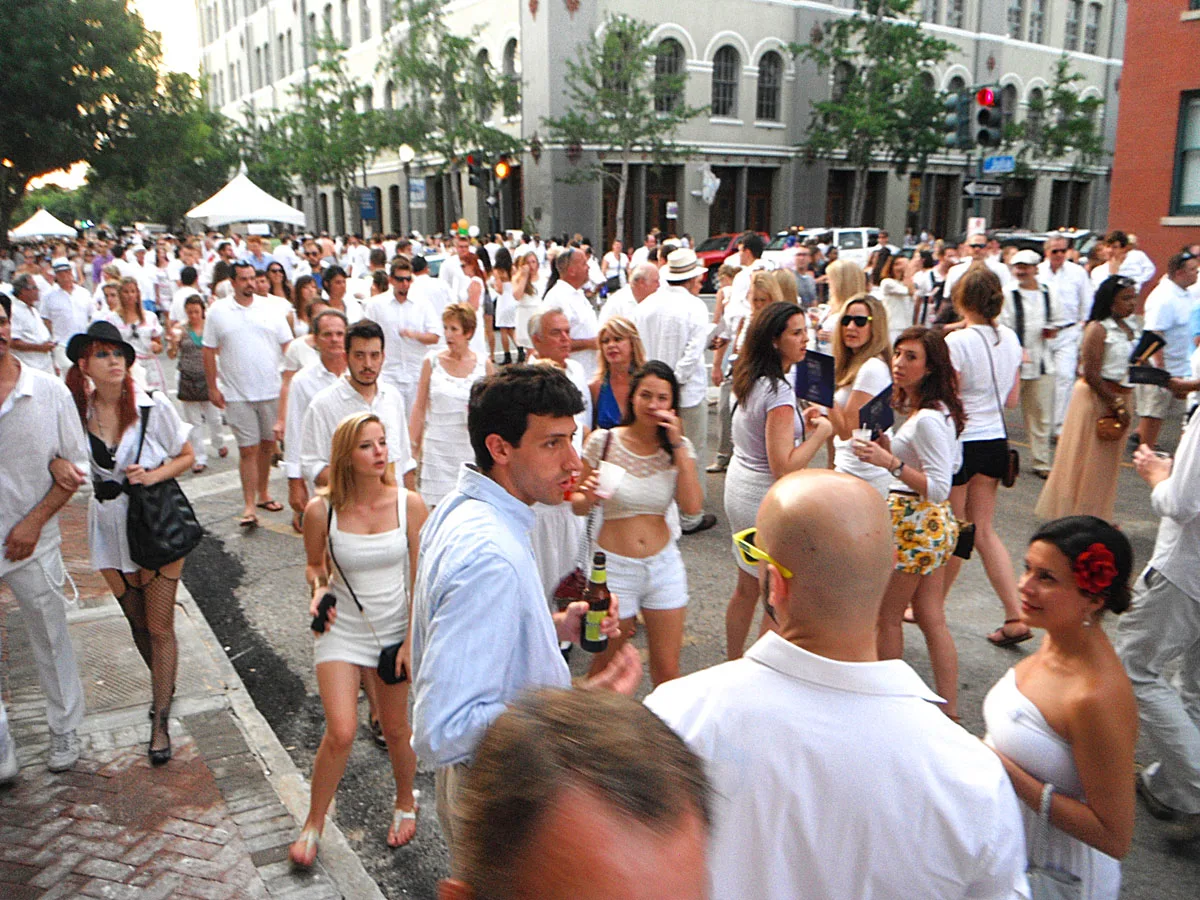 A crowd of people gathered in the streets dressed in White for the White Linen Night fetsival