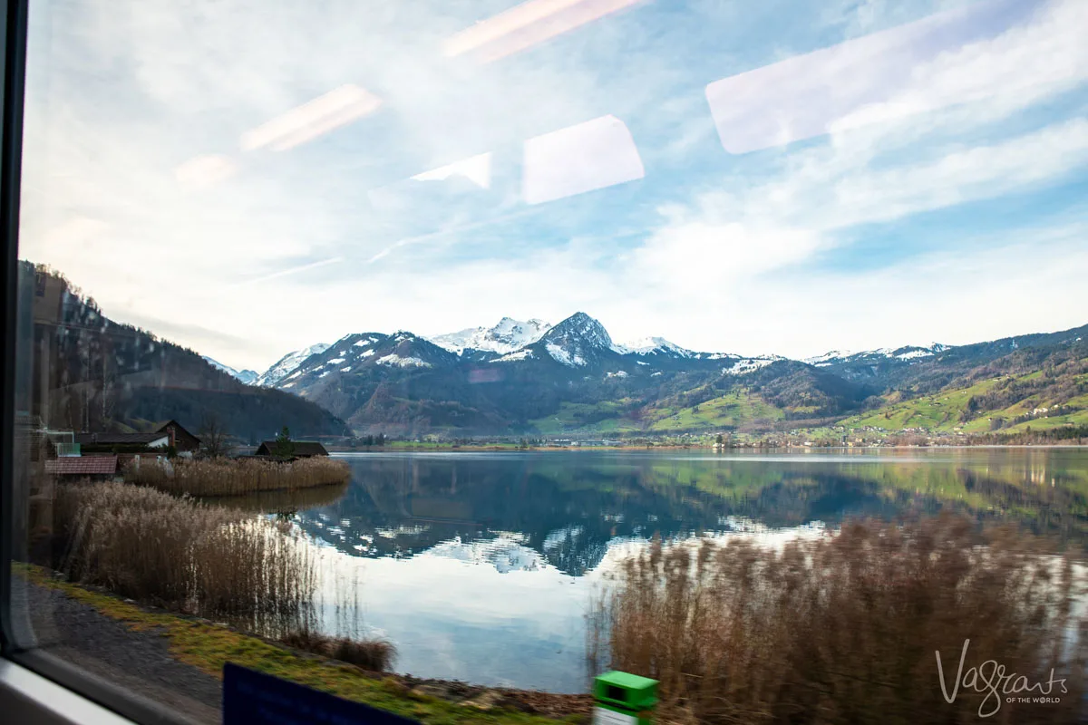 Views over a lake to the Swiss Alps from a bus