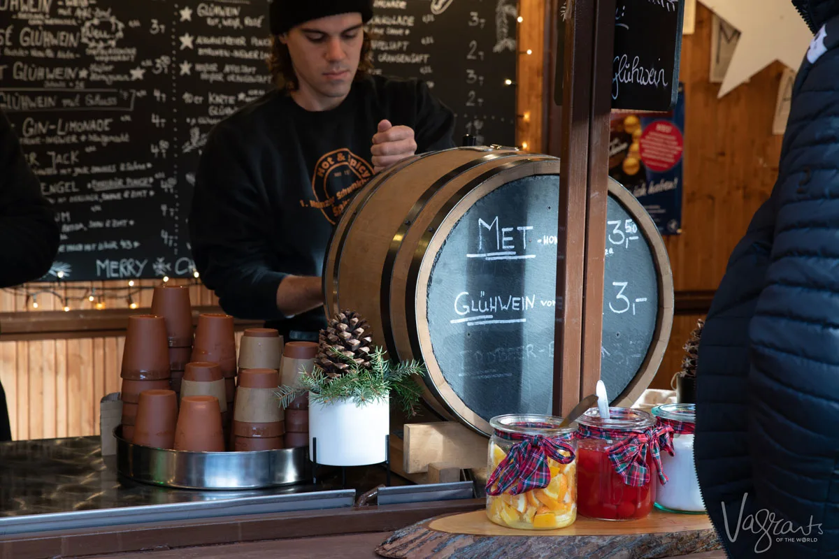 Man pouring Gluhwein from a barrel at a Christmas Market in Germany