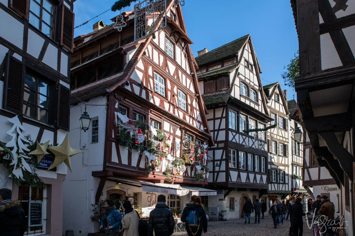 A typical street in Strasbourg old town with medieval wooden buildings on either side. 