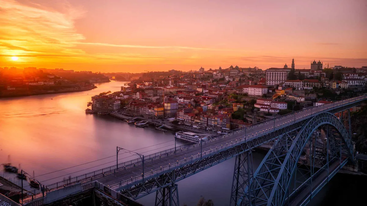 Sunrise over the Douro and Porto old town with the Dom Luis I bridge in the foreground.