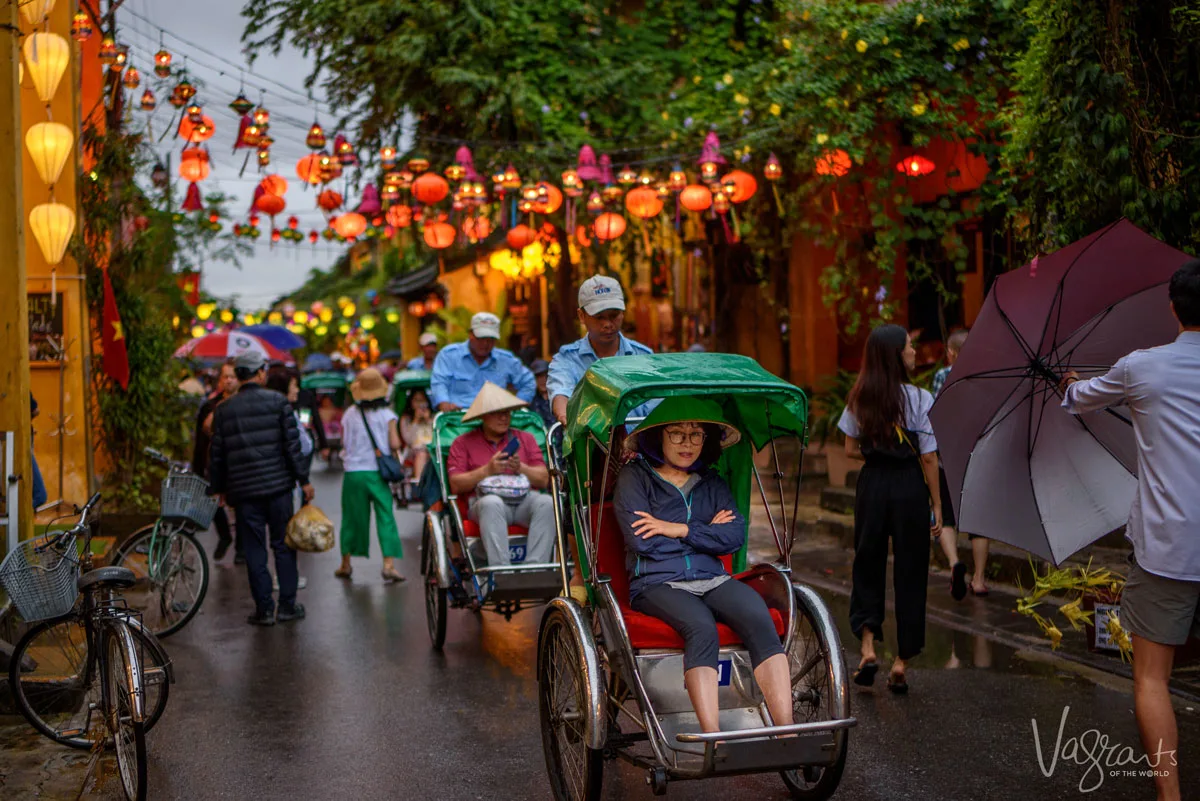 Lady taking a cyclo cab ride through the pretty streets of Old Town Hoi An