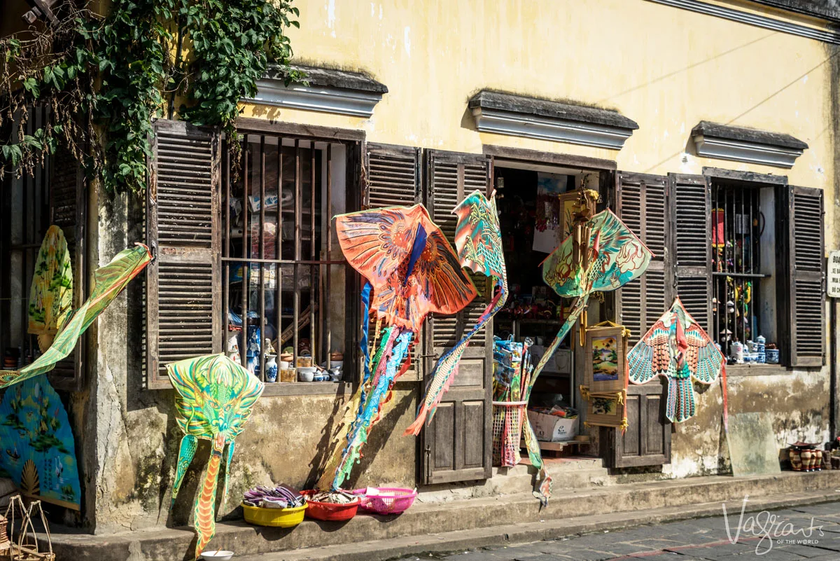 Colourful handmade kits hanging outside an old shop in Hoi An Old Town