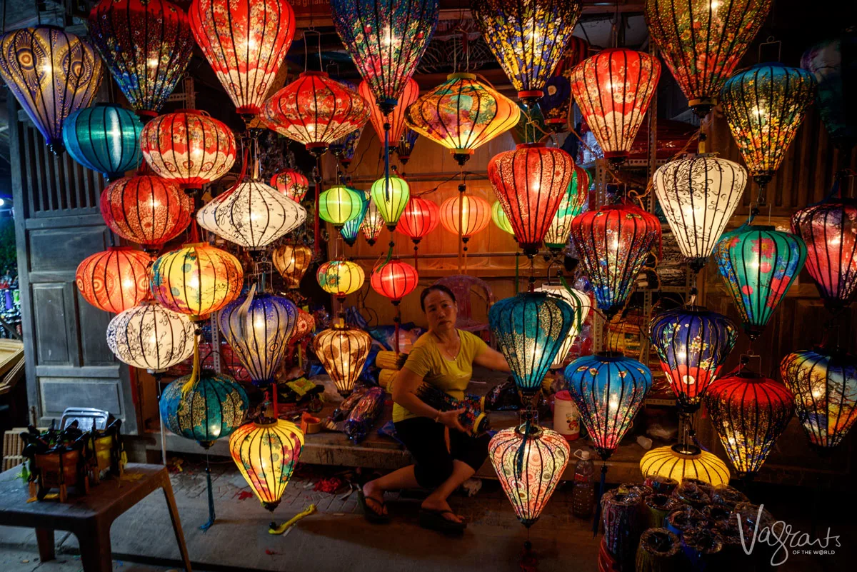 Vietnamese lady sits in a lantern stall in Hoi An Night Market. 