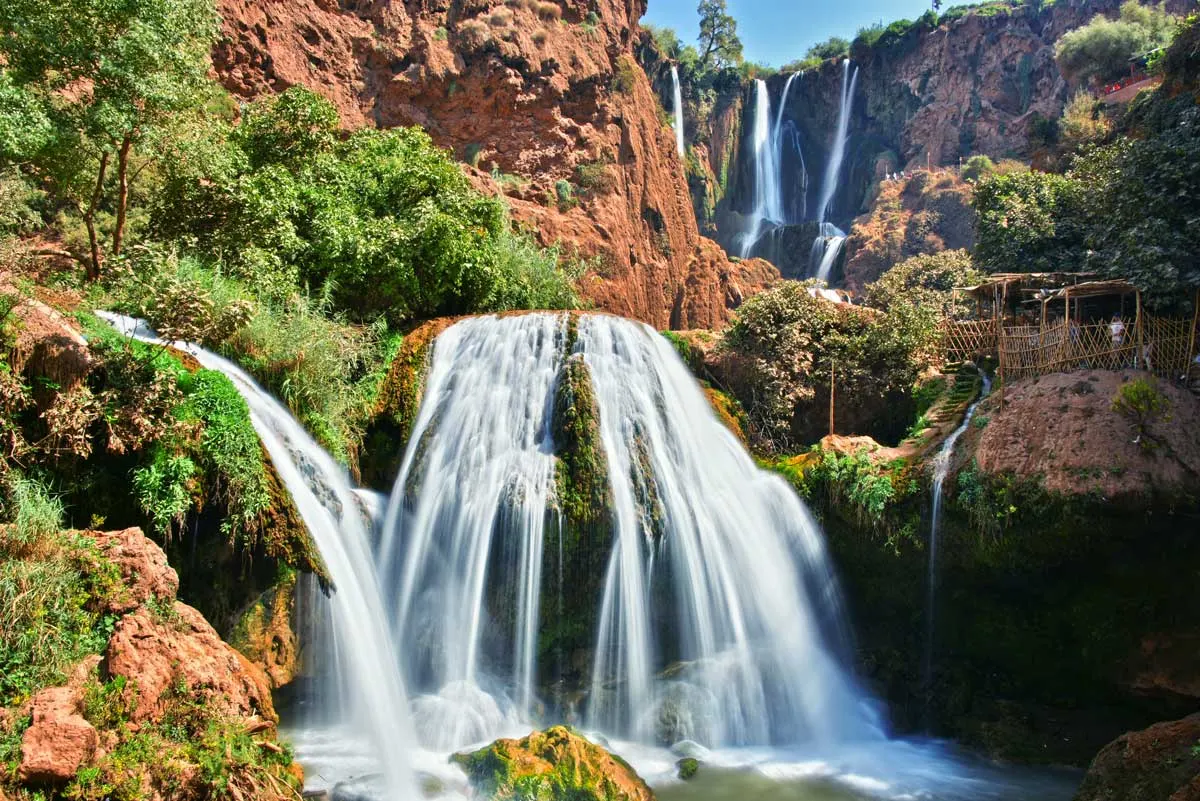 the cascading falls against the red gorge of Ouzoud Falls in Morocco. 