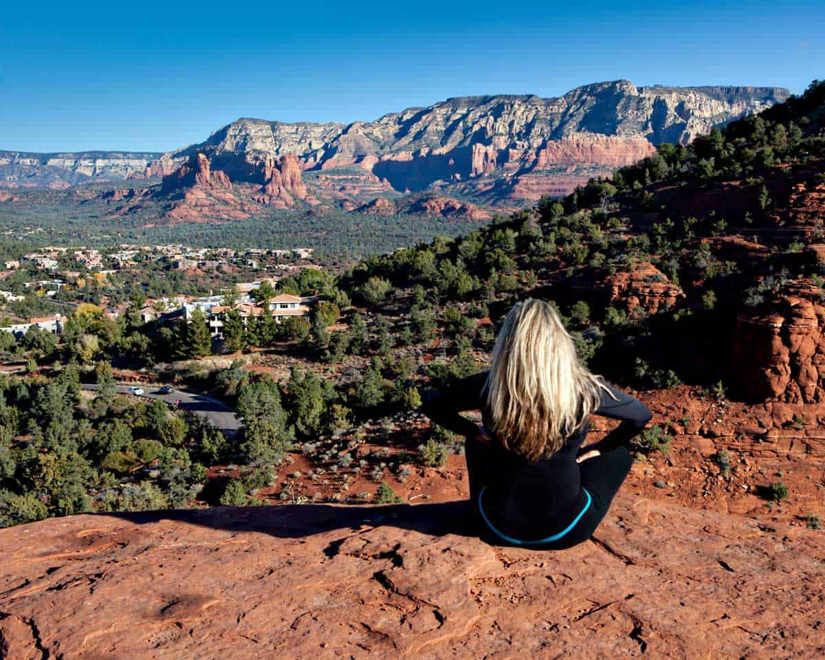 Girl sitting on a rock overlooking the town of Sedona