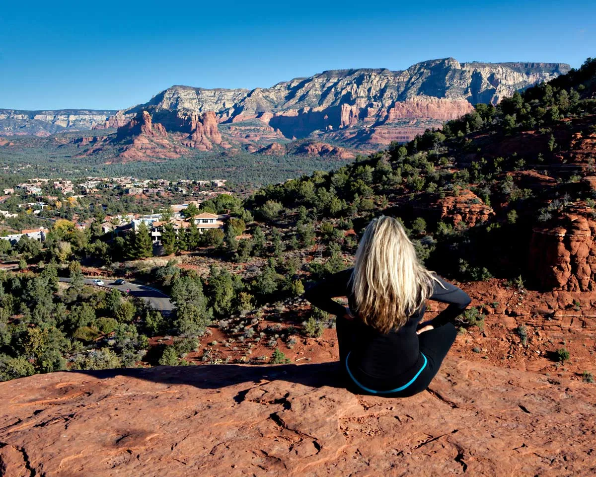 Girl sitting on a rock overlooking the town of Sedona