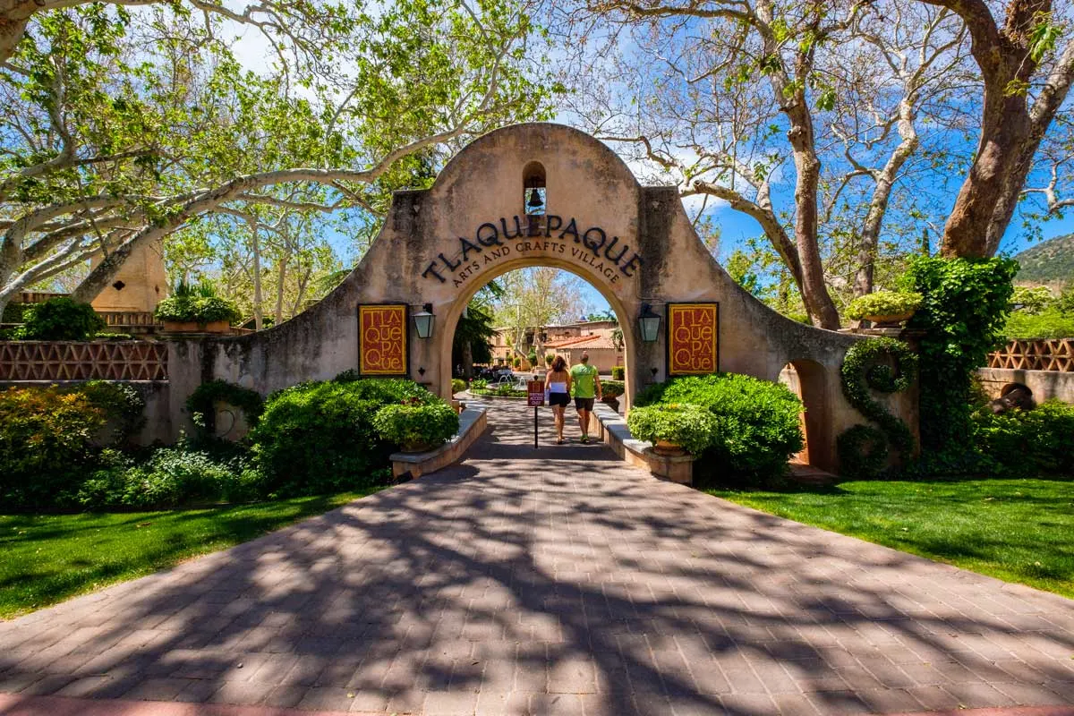 People walking through the gates into Tlaquepaque Village. 