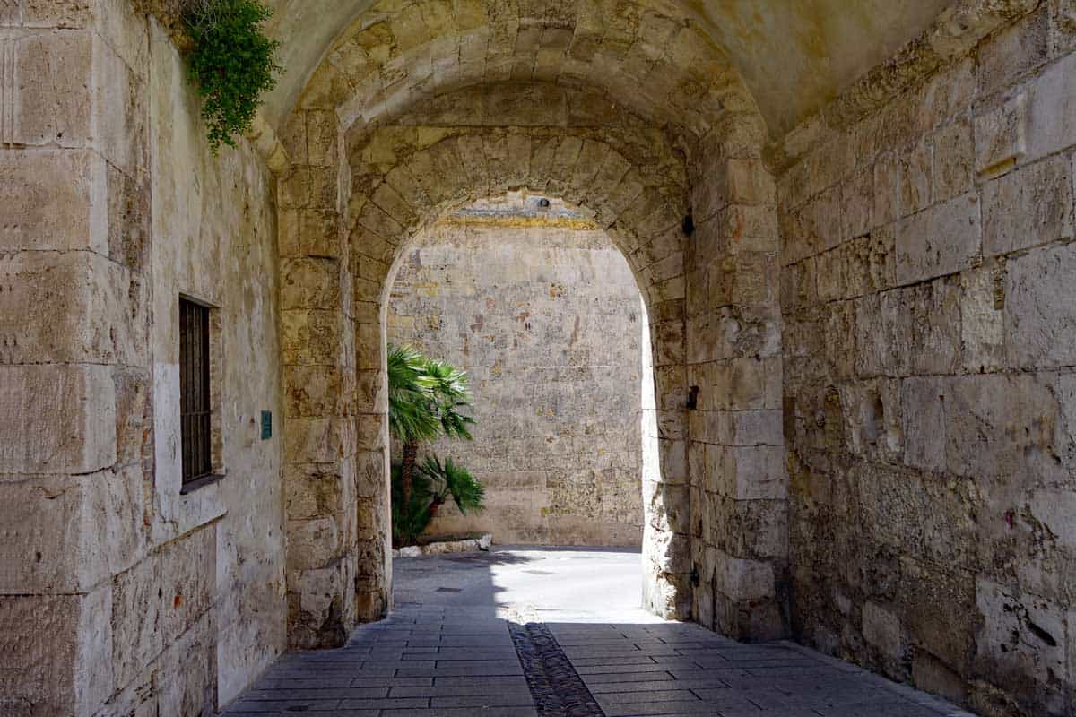 Stone arch alley way in the historic town of Cagliari in Sardinia. 