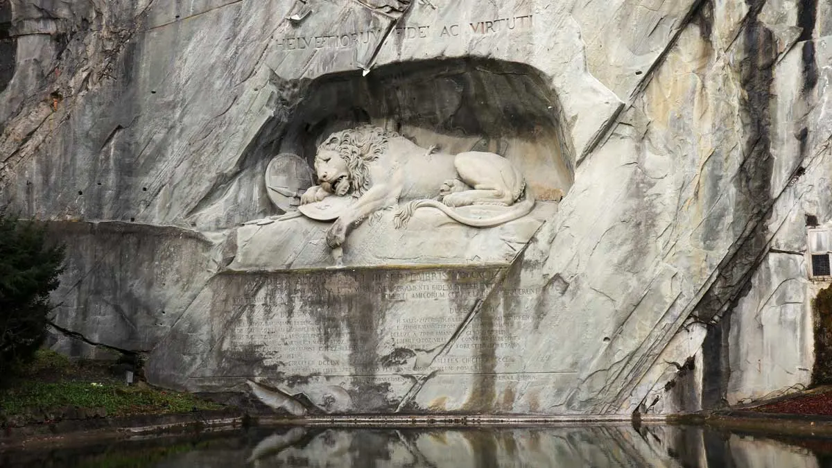 The Lion Monument carved into cliff.