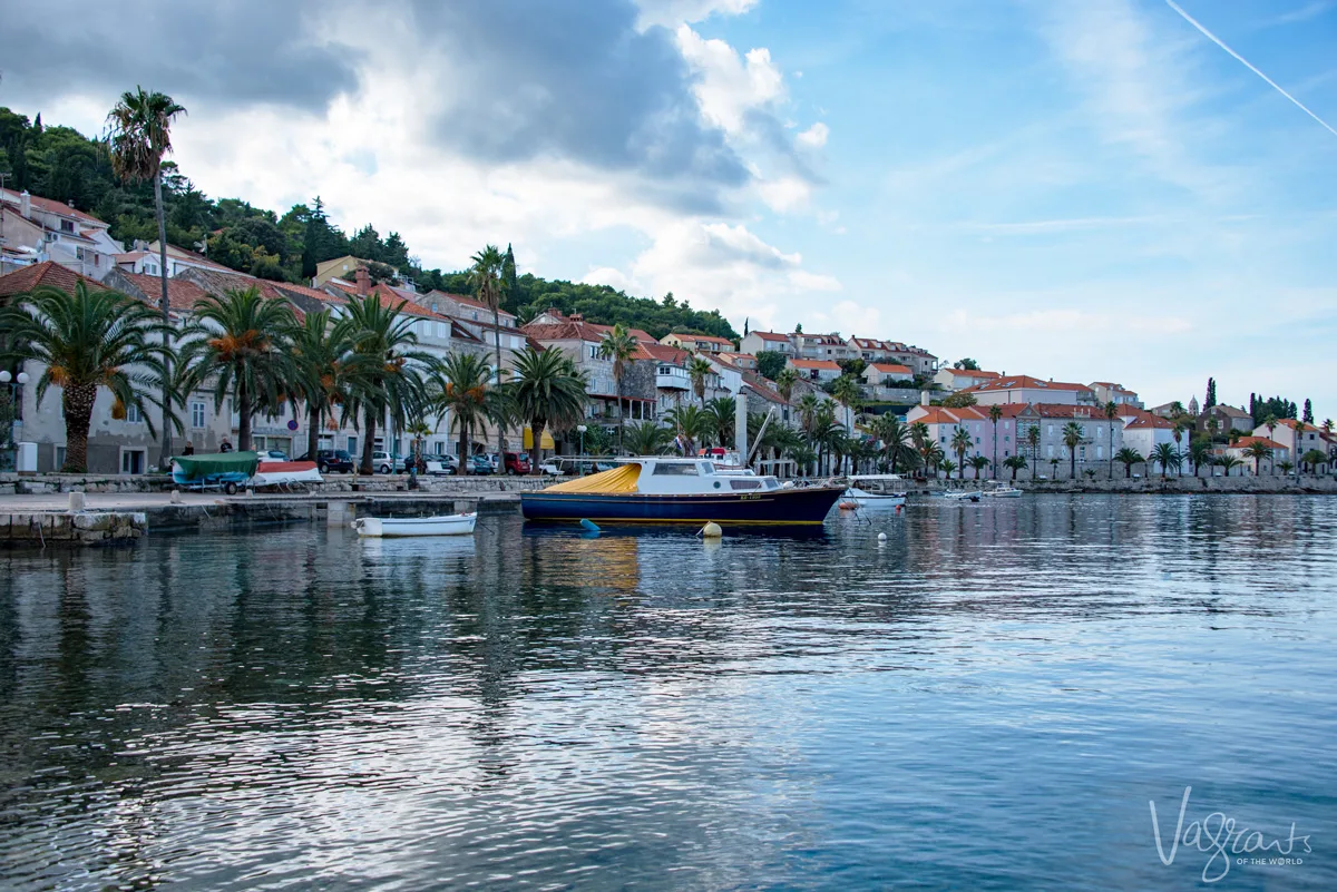 The still waters and palm tree lined waterfront of Korcula island, Croatia.