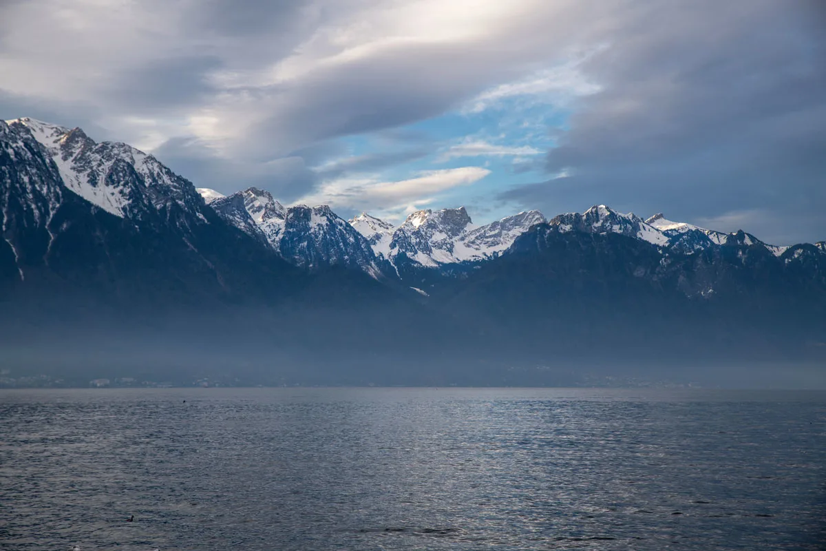 Clouds over the snow capped mountains and lake, Montreux