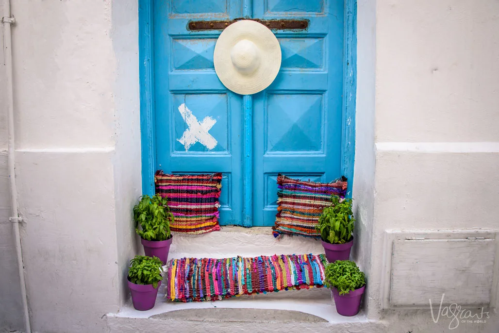 Blue doors and colourful cushions, mat and hat, welcome to Chora Old town,Mykonos.