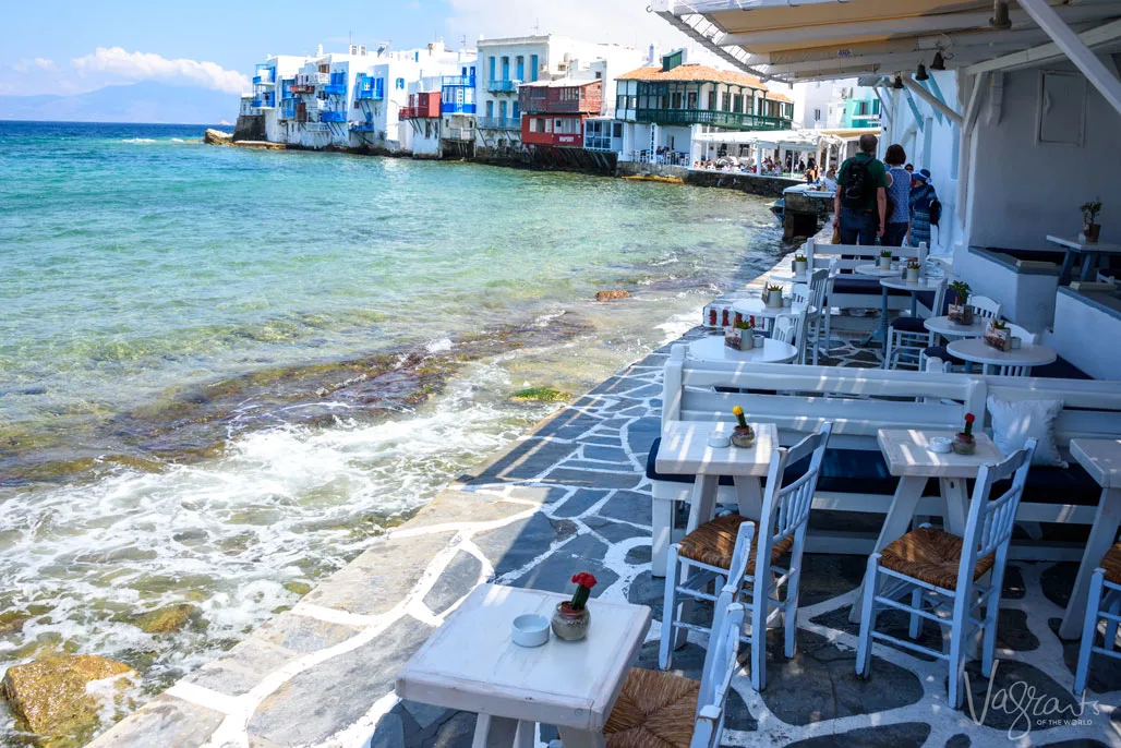 Water lapping the stone deck of outdoor restaurant in Little Venice, Mykonos.