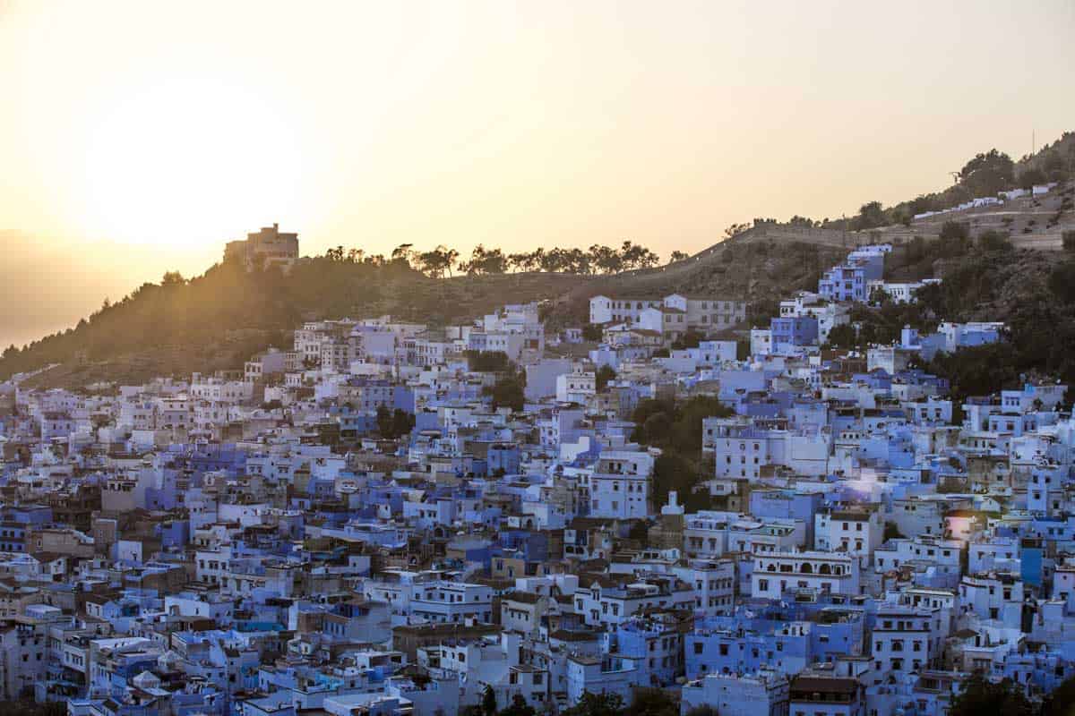 Blue and white city of Chefchaouen at sunset.