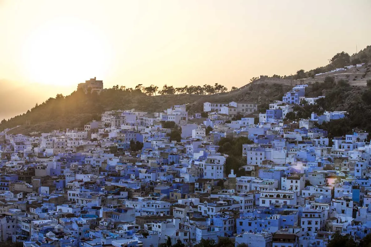 Blue and white city of Chefchaouen at sunset.