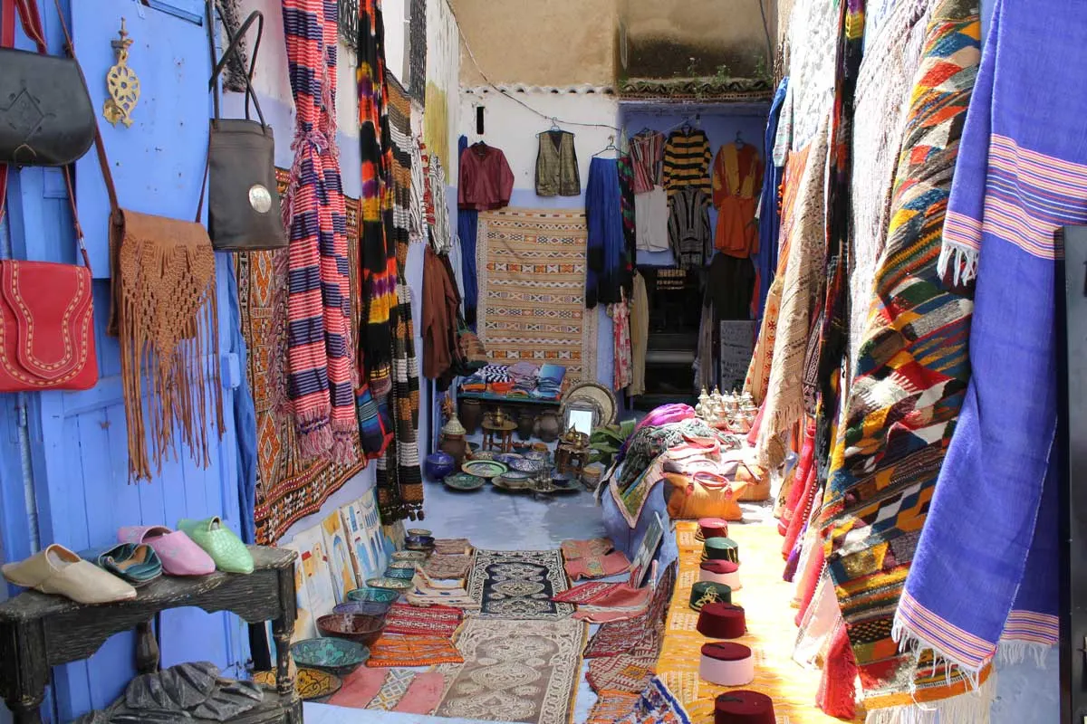 Shopping in the medina with shoes, handbags and mats.