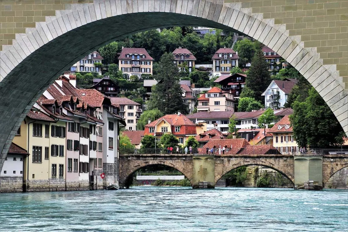 Arched stone bridges and terrace houses lining the river in old town, Bern