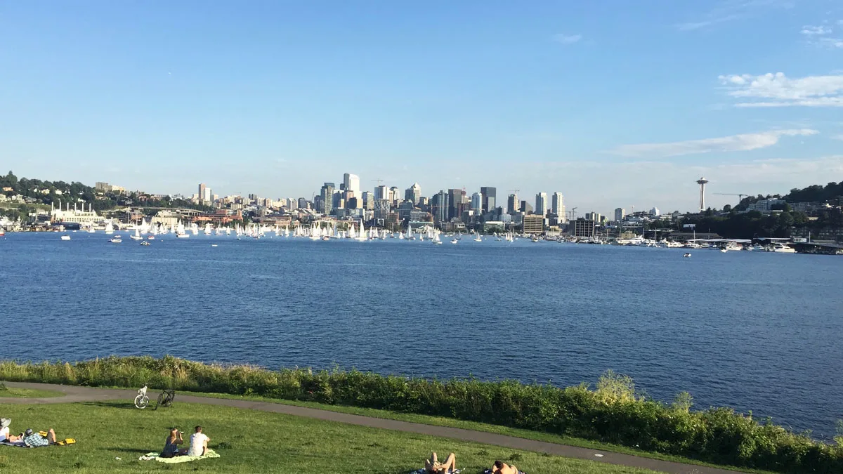People having a picnic in Gas Works Park overlooking Seattle city.