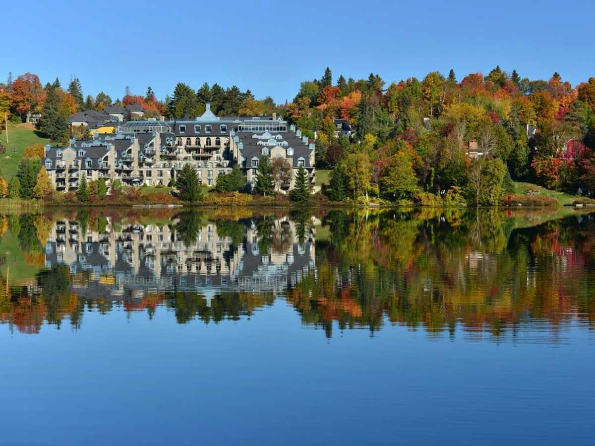 Lake reflections of grand hotel in Sainte-Adèle, perfect place to relax after a fall hike.