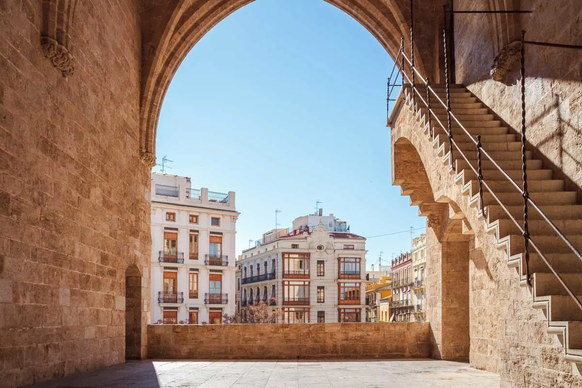 Stone walls and archway frame the beautiful buildings of Valencia,