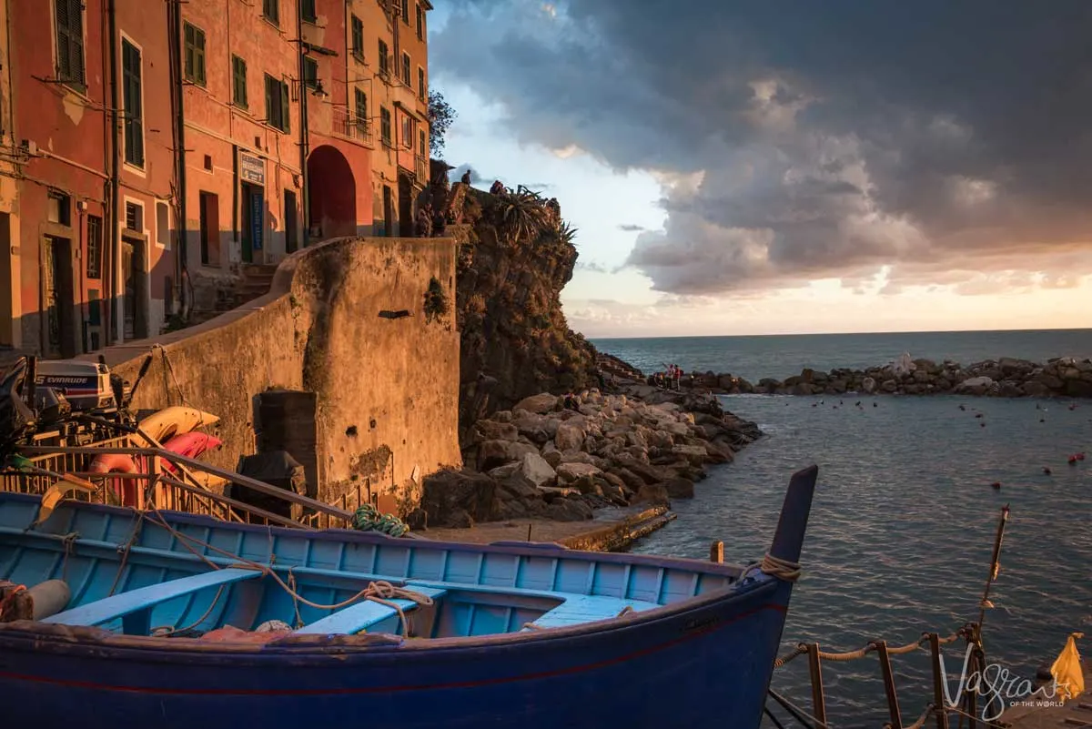 A Manarola sunset on the water with stormy clouds for some extra atmosphere.
