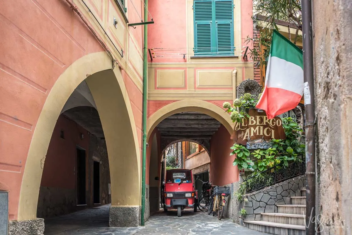 A little red ape parked on the cobblestones outside a hotel in Cinque Terre.