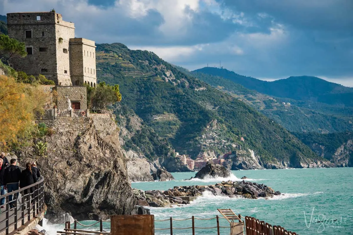 Clouds, castles and a rock shore line a magnificent sight at sunset in Cinque Terre.
