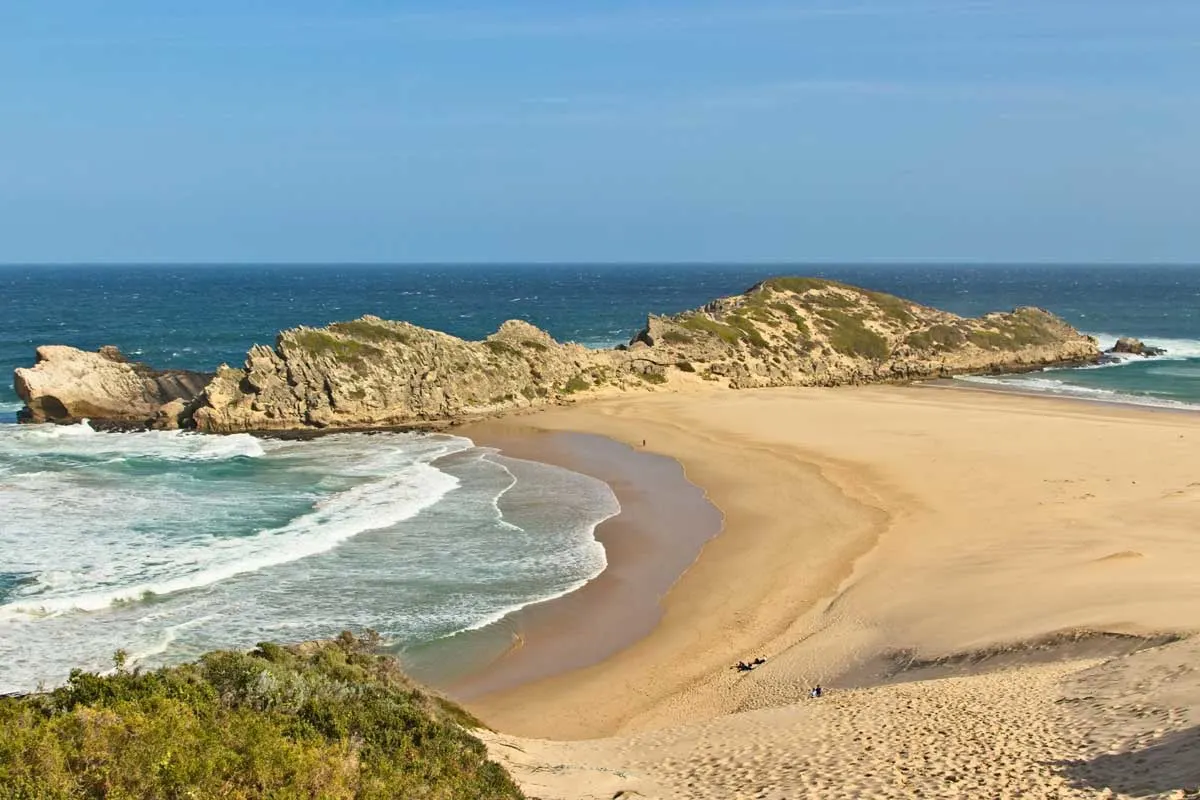 Secluded sandy beach and rocky headland, Plettenberg Bay.