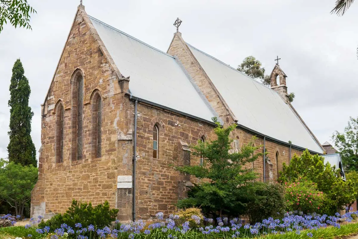 Purple flowers surrounding a church on the scenic Garden Route South Africa.