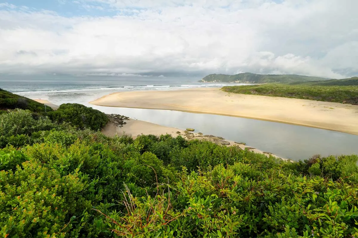 A river between two sandy beaches emptying into the sea at Sedgefield.